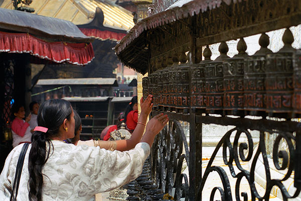 Pilgrims Spinning Prayer Wheels at Swayambhunath Stupa, Kathmandu, Nepal